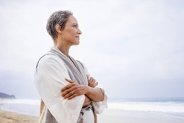 istock Senior Black Woman Relaxing on Beach 638304260
