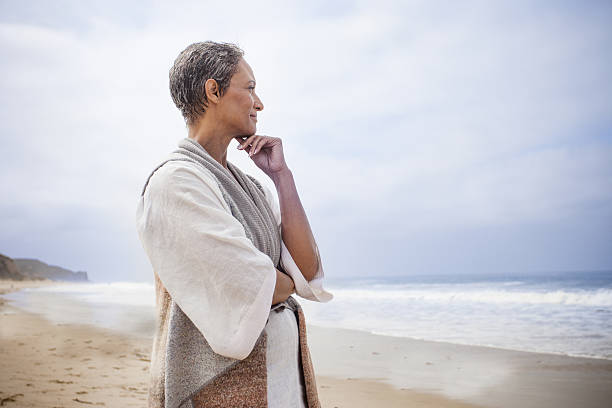 istock Senior Black Woman Relaxing on Beach 638304266