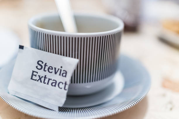 petite tasse de café sur l’assiette avec paquet d’extrait de stevia - alternative medicine nature herbal medicine healthcare and medicine photos et images de collection