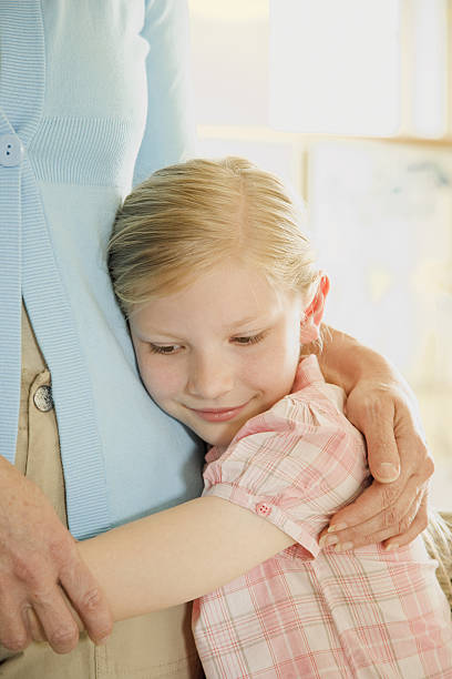 Daughter holding mother and being comforted
