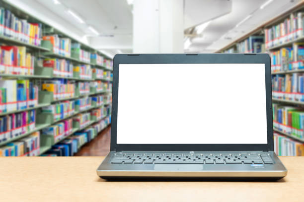 istock Laptop with blank screen on table with blur bookshelf 638307406