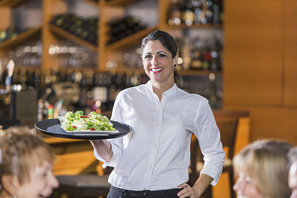 istock Waitress in restaurant serving food to customers 638308008