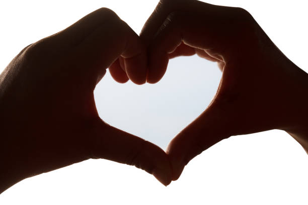 istock Silhouette of heart shape hand 638309594