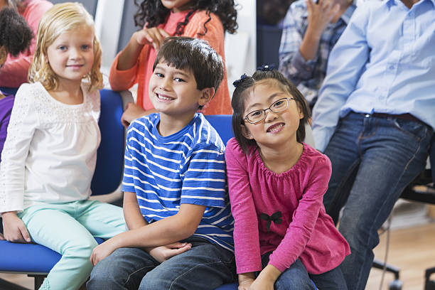 istock Multi-ethnic group of children sitting together 638309672