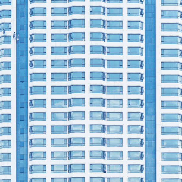 istock Close up of office building with reflection of blue sky 638310580