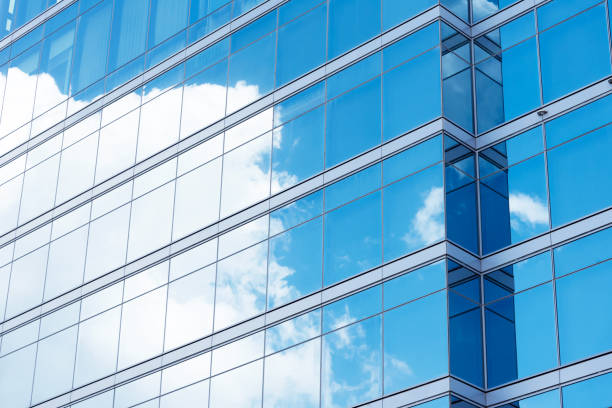 istock Office building with reflection of blue sky and cloud 638310608