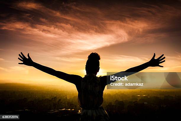 African American Woman Raising Arms At Sunset Stock Photo - Download Image Now - Women, One Woman Only, In Silhouette
