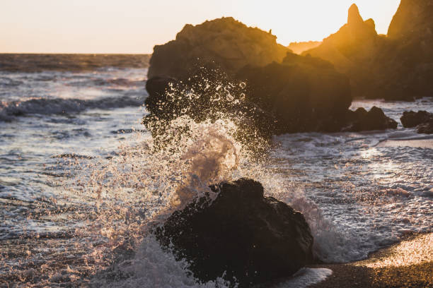 istock Waves crashing on rocks in sunlight. Spray fly away 638317304