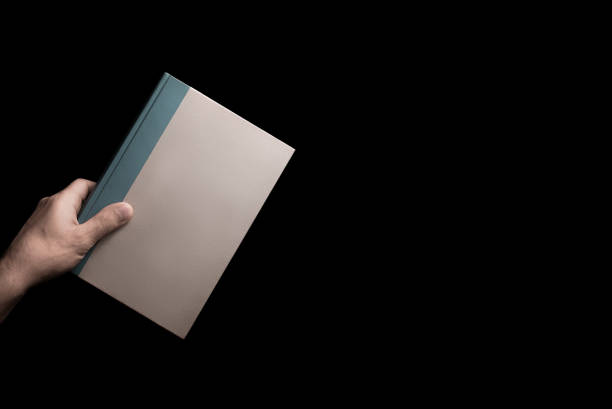 istock book in male hand 638318652