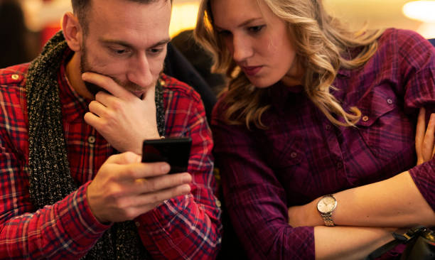 istock Young beautiful couple with smart phone 638325718