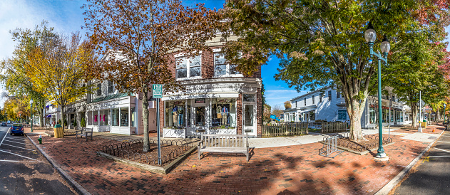 East Hampton, United States - October 27, 2015: view to Main street in East Hampton with old victorian wooden buildings on a sunny day.