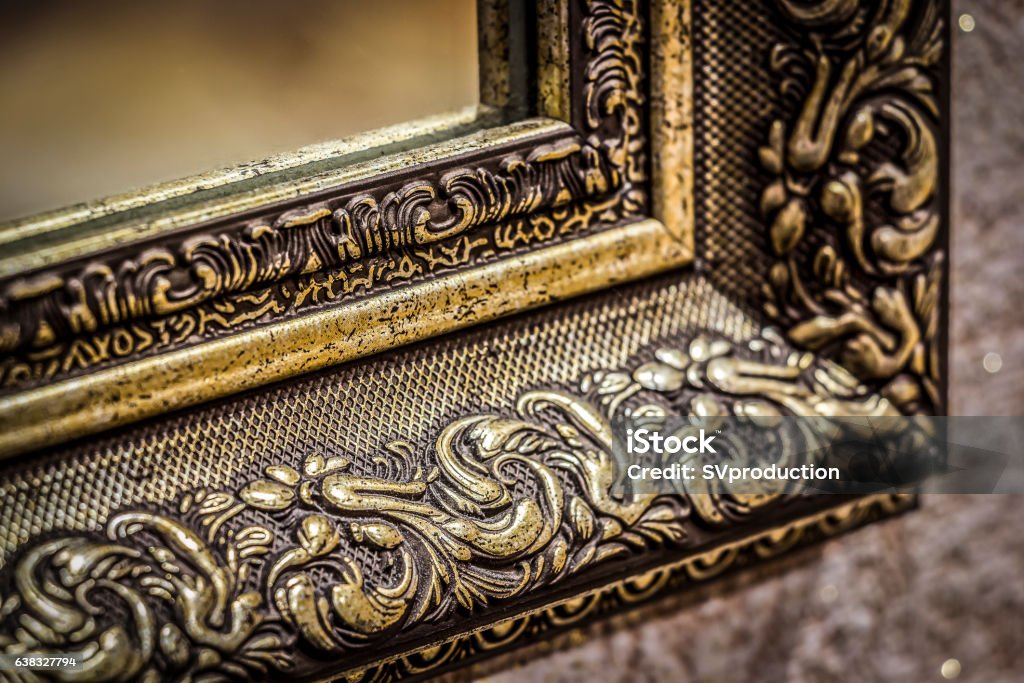 Part of the mirror frame Part of the ornate, carved mirror frame in ancient style. Luxury Stock Photo