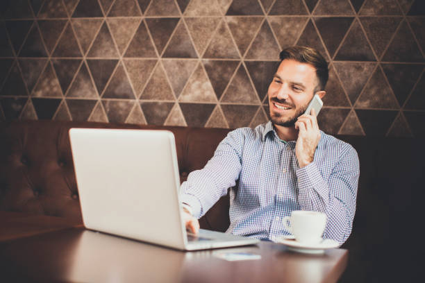 istock Young man with laptop and mobile phone 638332484