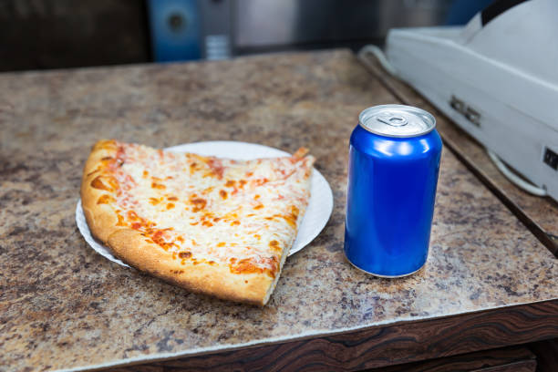 Pizza slice and bank of soda