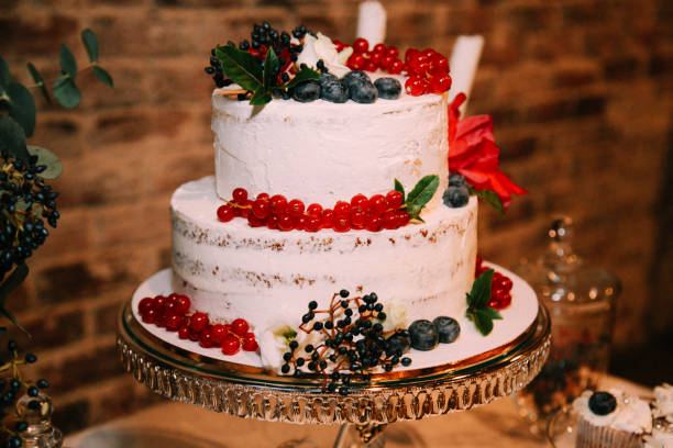 istock White wedding cake with berries on a tray 638333118