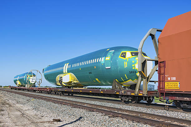 Two Boeing 737 aircraft fuselages on BNSF train Walton, United States - May 4, 2016: The Boeing 737 aircraft fuselage train transporting 737 fuselages on specially modified freight railcars, passes the town of Walton near the start of its journey from Spirit Aerosystems (Boeing) in Wichita KS, to aircraft assembly plants in Renton and Everett near Seattle WA.  wichita photos stock pictures, royalty-free photos & images