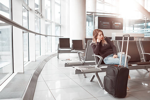 istock bored woman waiting for her flight 638335250