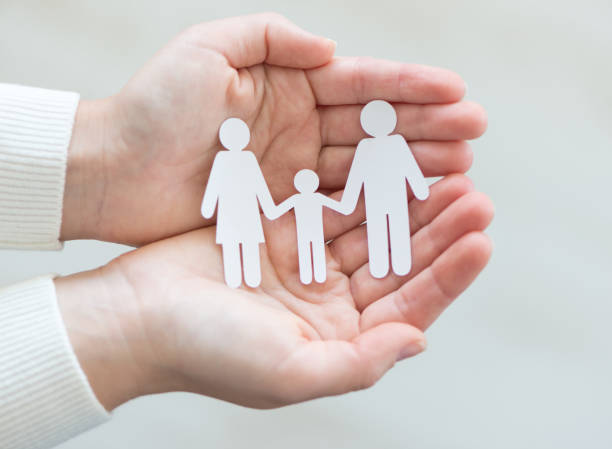 istock Paper cut family in hands 638336124