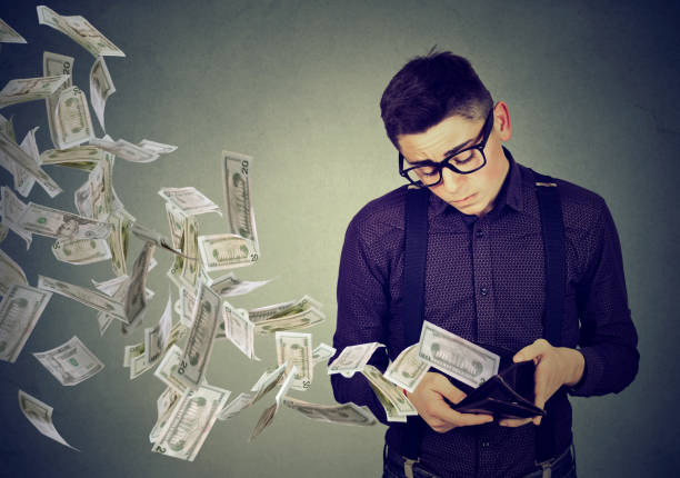 istock Man looking at wallet money dollar banknotes flying away 638337824