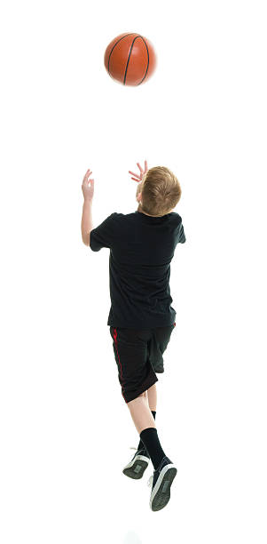 istock Rear view of man playing basketball 638337948