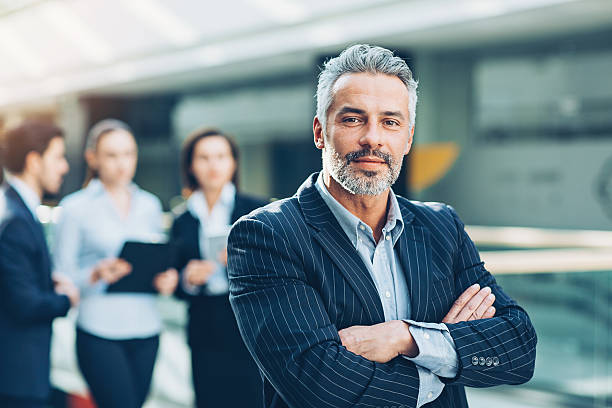 istock Successful mature businessman with his team 638338144