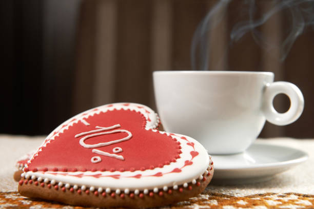 Coffee service with red poppies. Vintage cup of coffee with cream and a saucer with chocolate sweets.