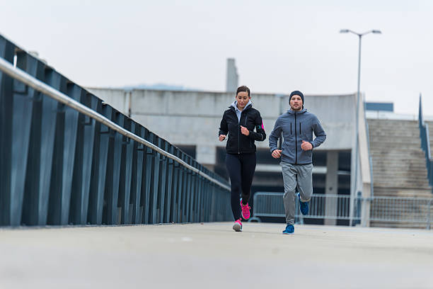 istock Young couple running together 638341814