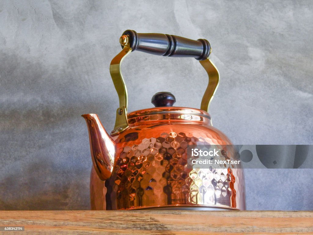 Old fashioned Copper Kettle on shelf. Old fashioned Copper Kettle on wood shelf. Ancient Stock Photo