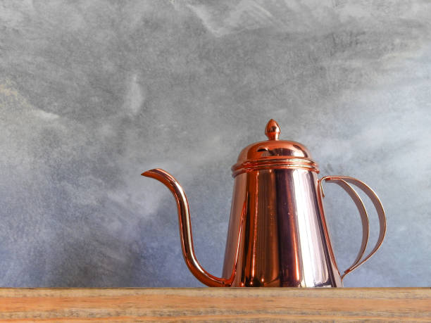 istock Copper coffee pots on wood shelf for interior. 638342184