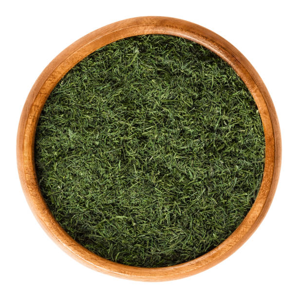 istock Dried dill fronds in wooden bowl over white 638342704