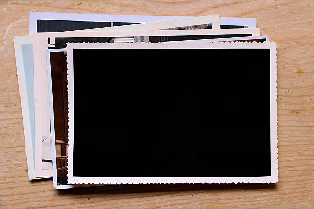 istock Old photographs on wood table (with clipping path) 638345956
