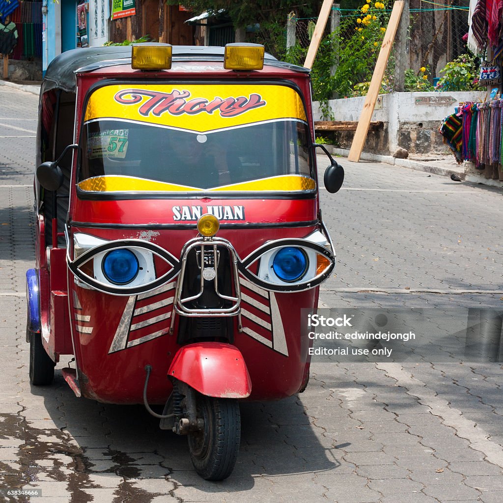 Tricycle motor rickshaw taxi (tuk tuk). San Juan La Laguna, Guatemala - April 27, 2016: Tricycle motor rickshaw taxi (tuk tuk). Guatemala is loaded with these little vehicles, taking people, both tourists and locals, from place to place.  American Culture Stock Photo