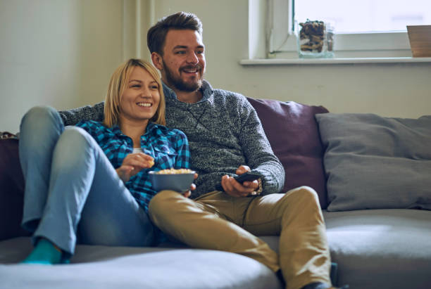 istock Couple at home watching TV 638349224