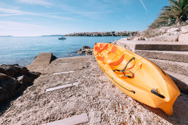 istock Bright orange kayak is on the sea pier 638349618