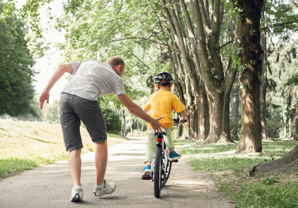 istock Father learn his little son to ride a bicycle 638349640