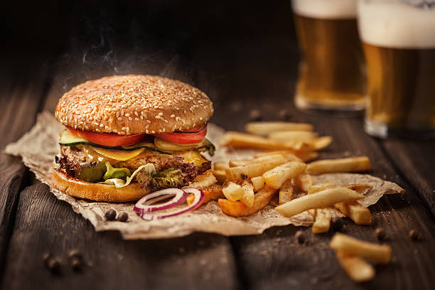 tasty hamburger with french fries and beer on wooden table - bacon cheeseburger imagens e fotografias de stock