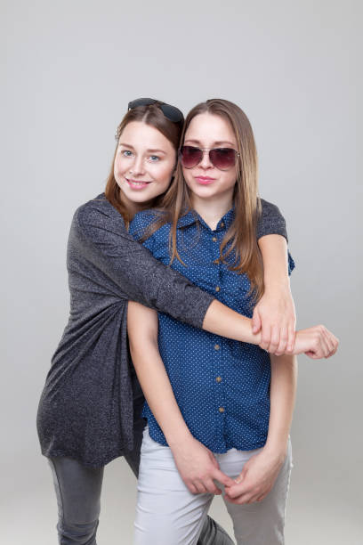 istock Studio portait of young twin sisters embracing 638350210