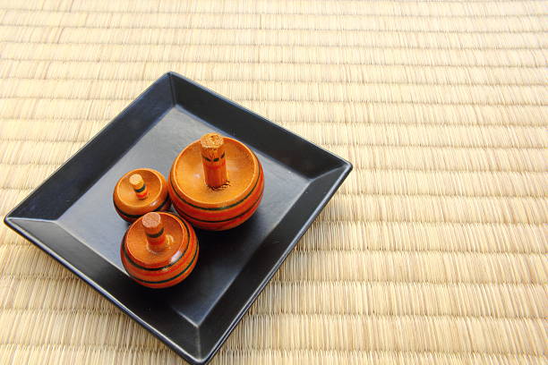Triple tops on black ceramic plate put on Tatami flooring mat