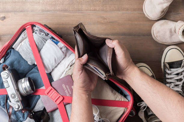 istock Empty wallet in the hand man on Travel accessories  background 638354564