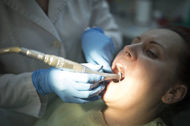 istock Dentist curing a female patient 638355260