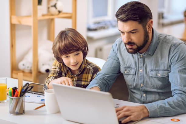 istock Father and son playing games together 638356906