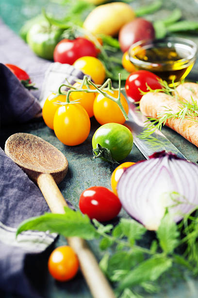 istock Wooden spoon and fresh organic vegetables on old background 638357078