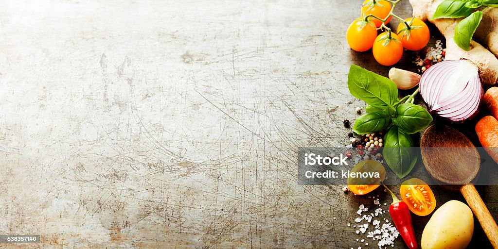 Wooden spoon and fresh organic vegetables on old background Wooden spoon and ingredients on old background. Vegetarian food, health or cooking concept.  Background layout with free text space. Backgrounds Stock Photo