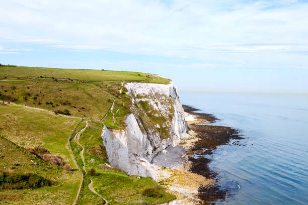 Coastal walking path overlooking the English Channel and white cliffs of Dover, south east England, on a sunny summer day
