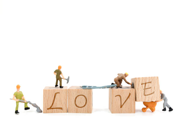 Miniature worker team building word love on white background