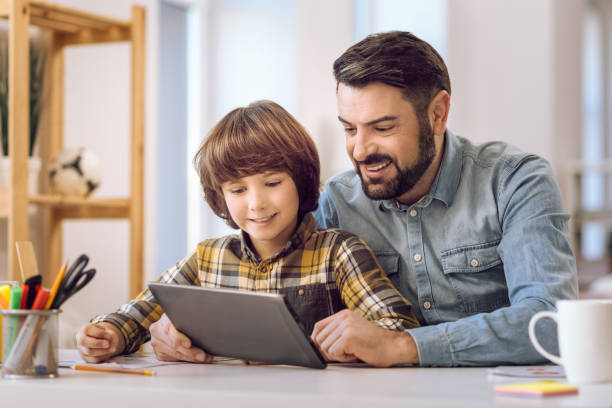 istock Delighted man showing picture on tablet 638357686