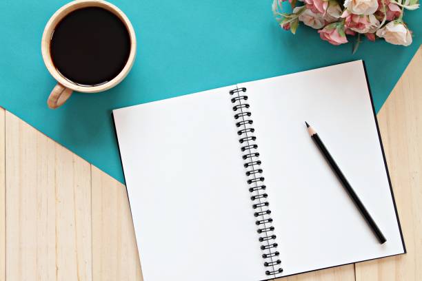 istock Notebook, pencil, coffee cup and flowers on wooden background 638358396