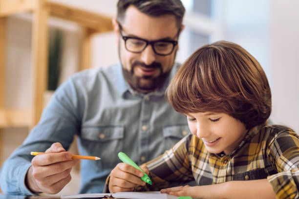 istock Happy boy painting in his notebook 638359540