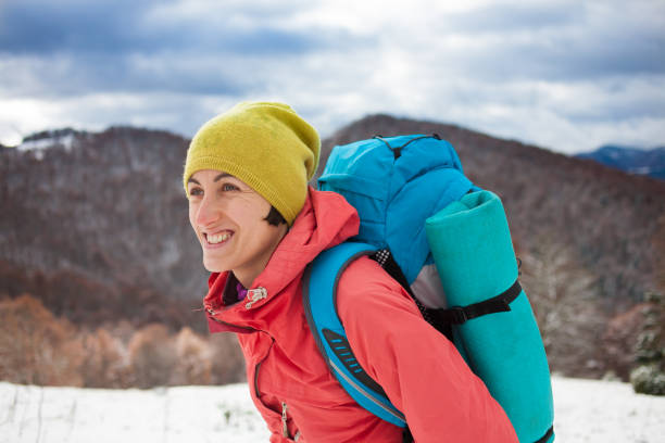istock Girl with backpack walking on snow in the mountains. 638359626