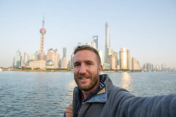 istock Young man taking selfie portrait in Shanghai, China 638361142